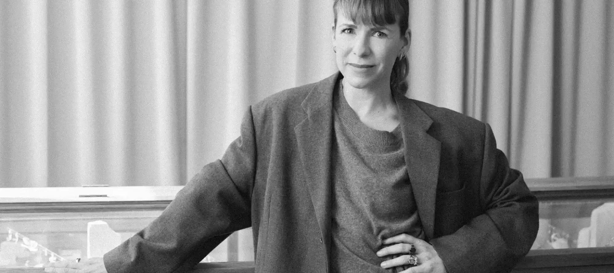 Black and white portrait of a woman in an oversized blazer.