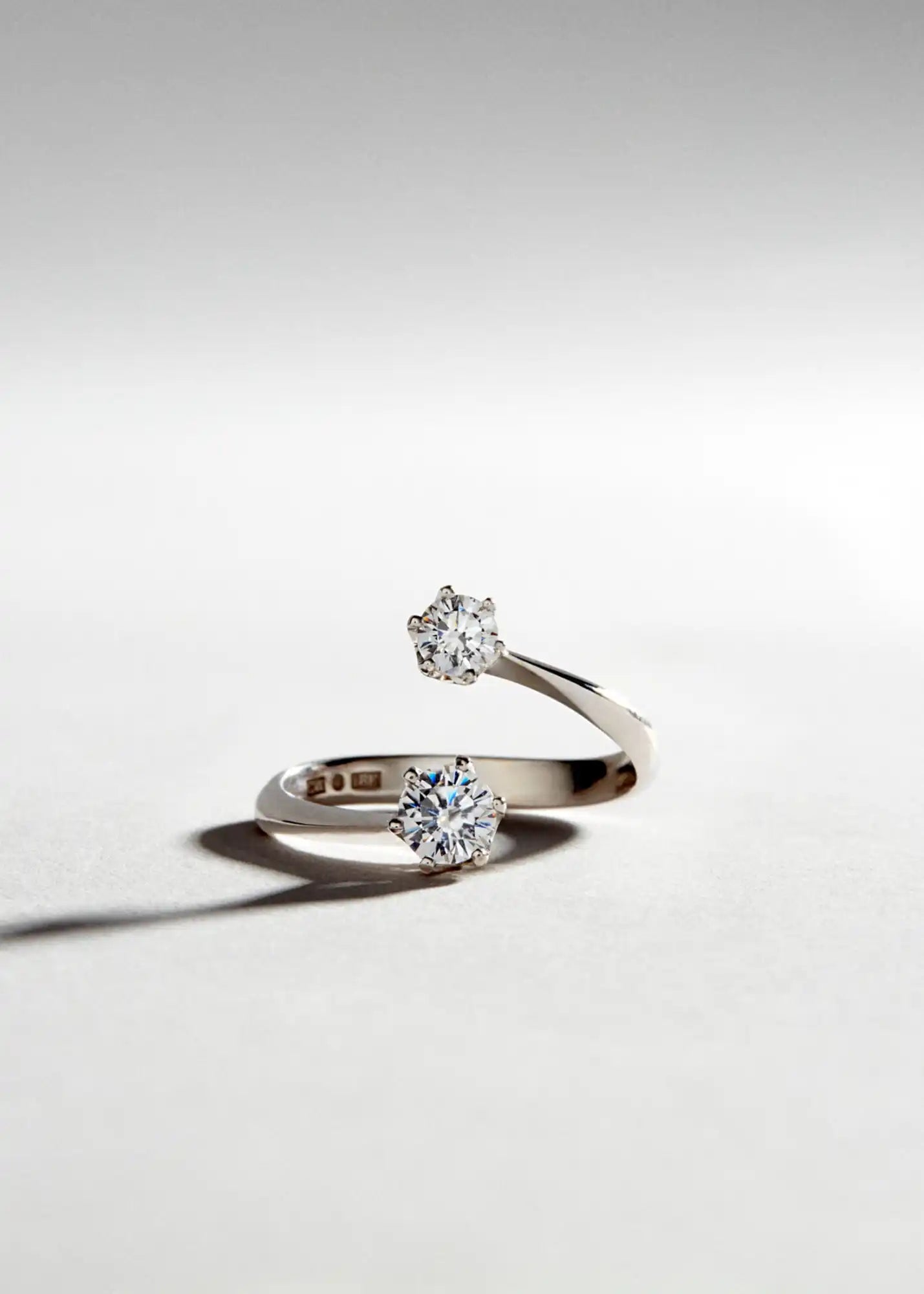 Elegant diamond-studded bypass ring.