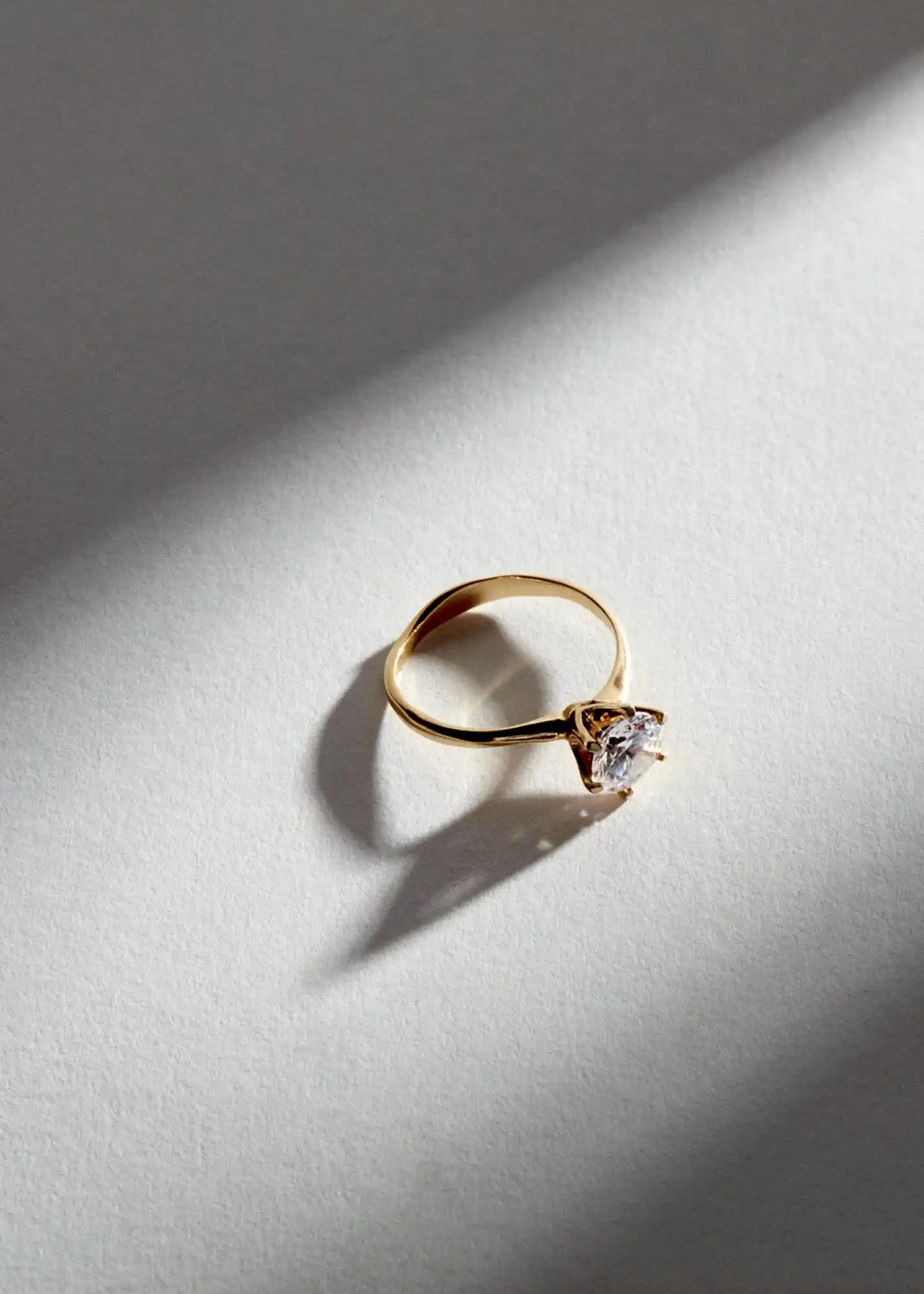 Gold ring with a square-cut diamond.