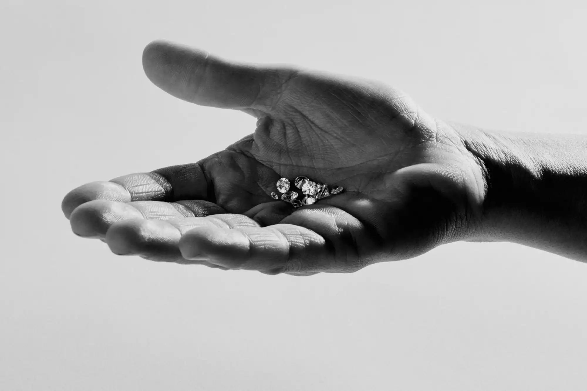 Hand holding a diamond ring.