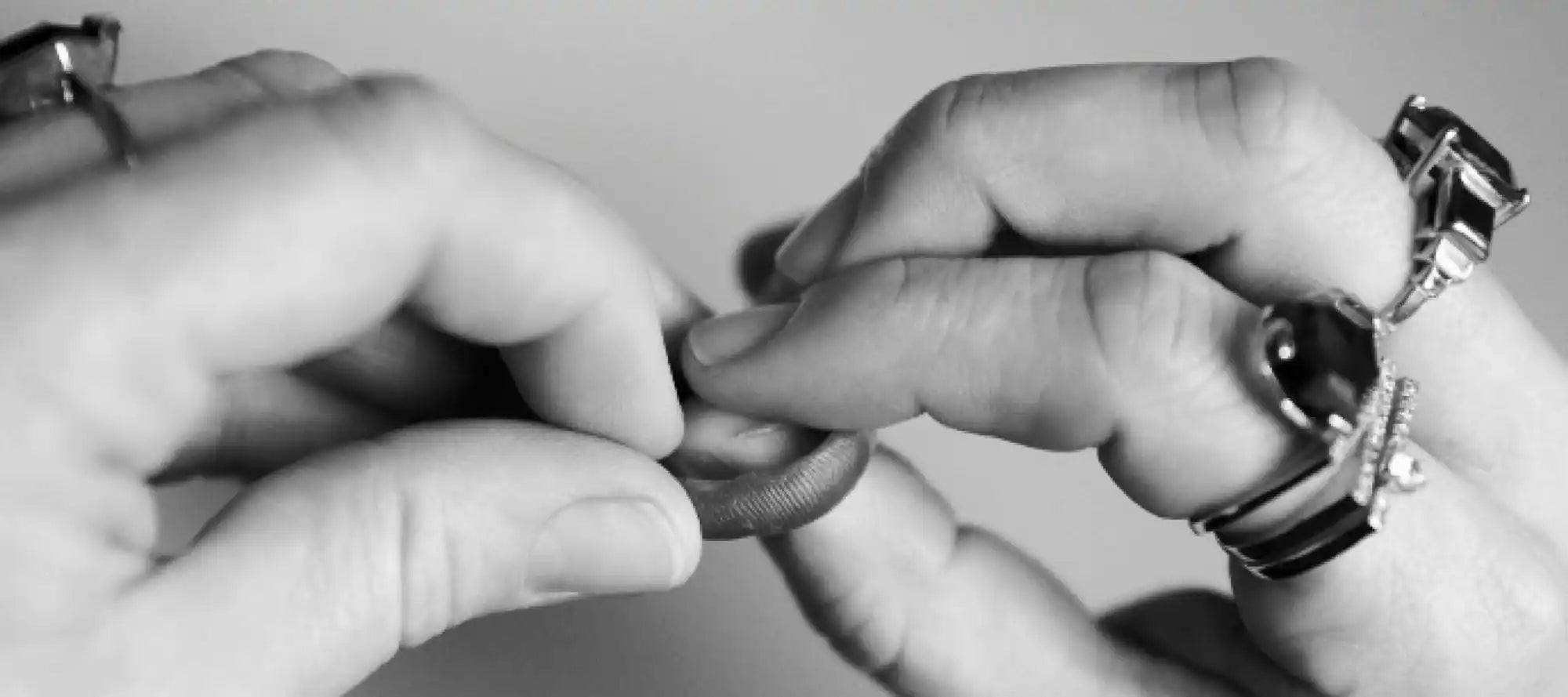 Hands holding a ring.