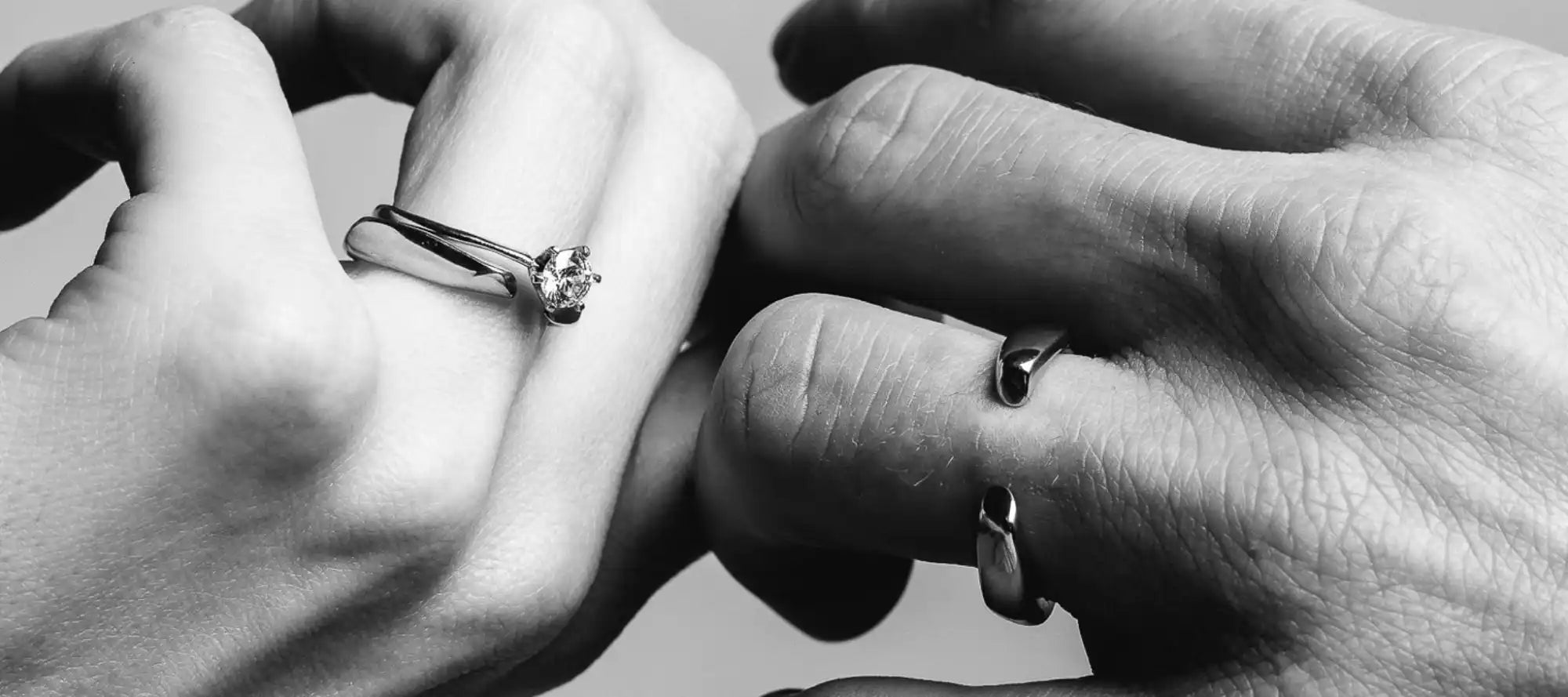 Interlocked fingers with rings.