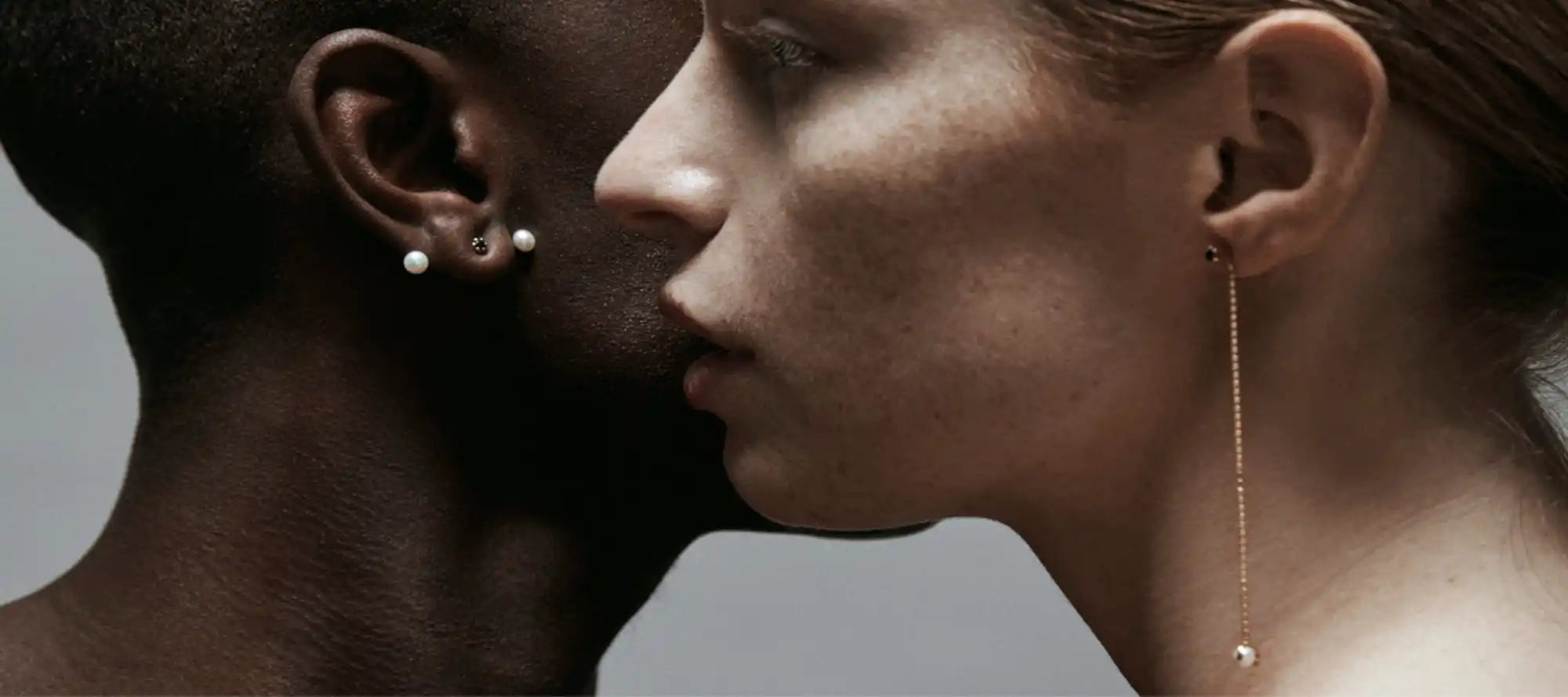 Interracial couple’s close-up profile.