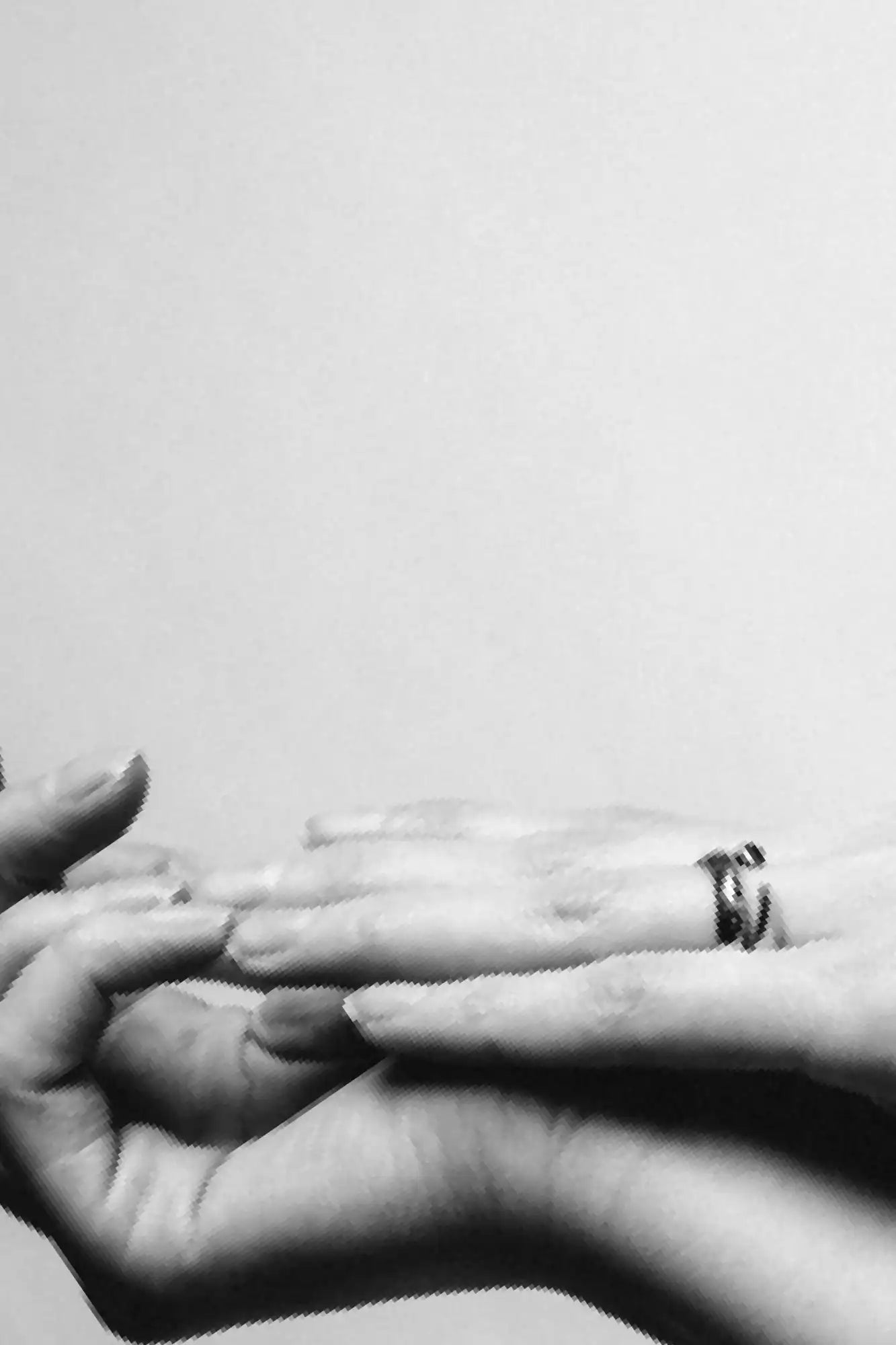 Intertwined hands with rings.