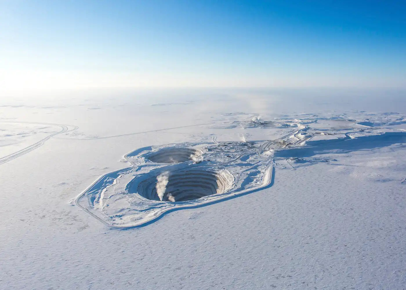 Massive, snow-covered open-pit mine.