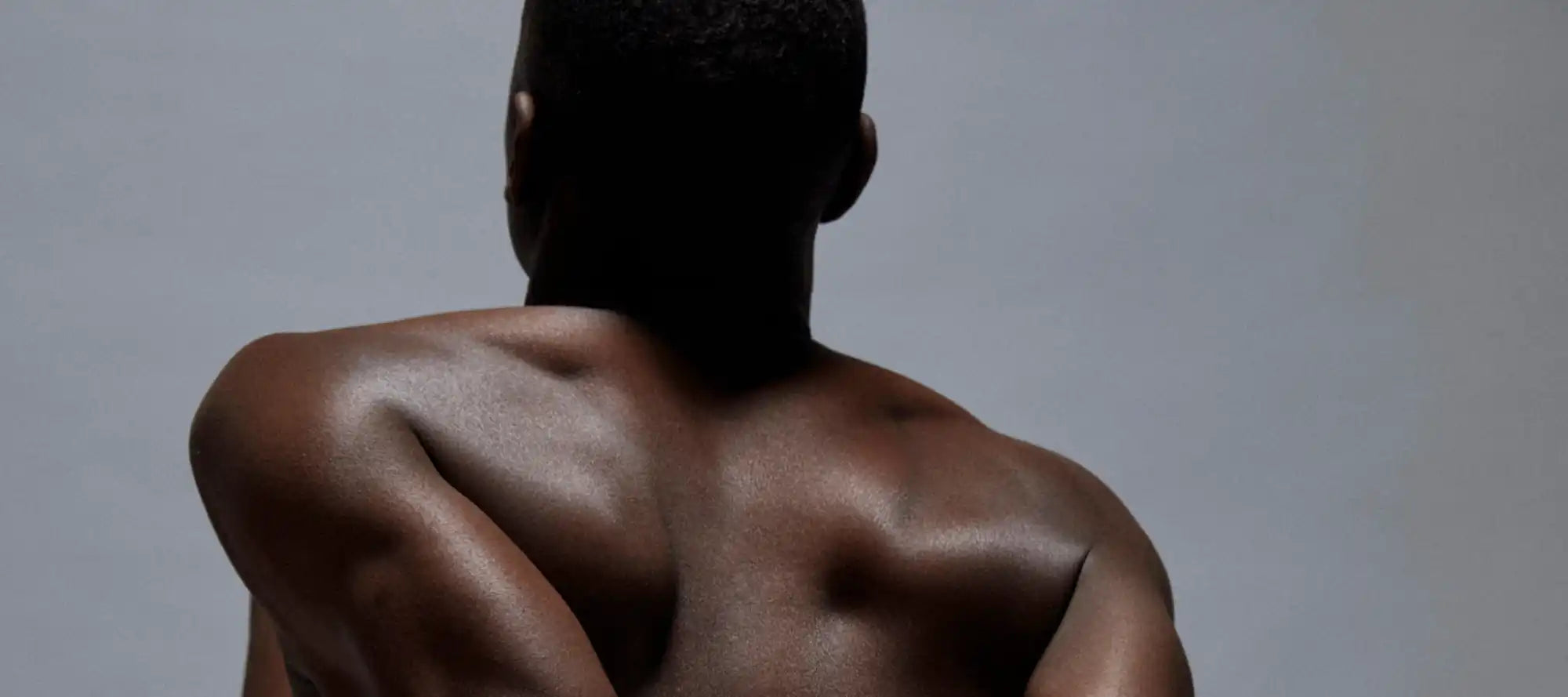 Muscular, dark-skinned back.