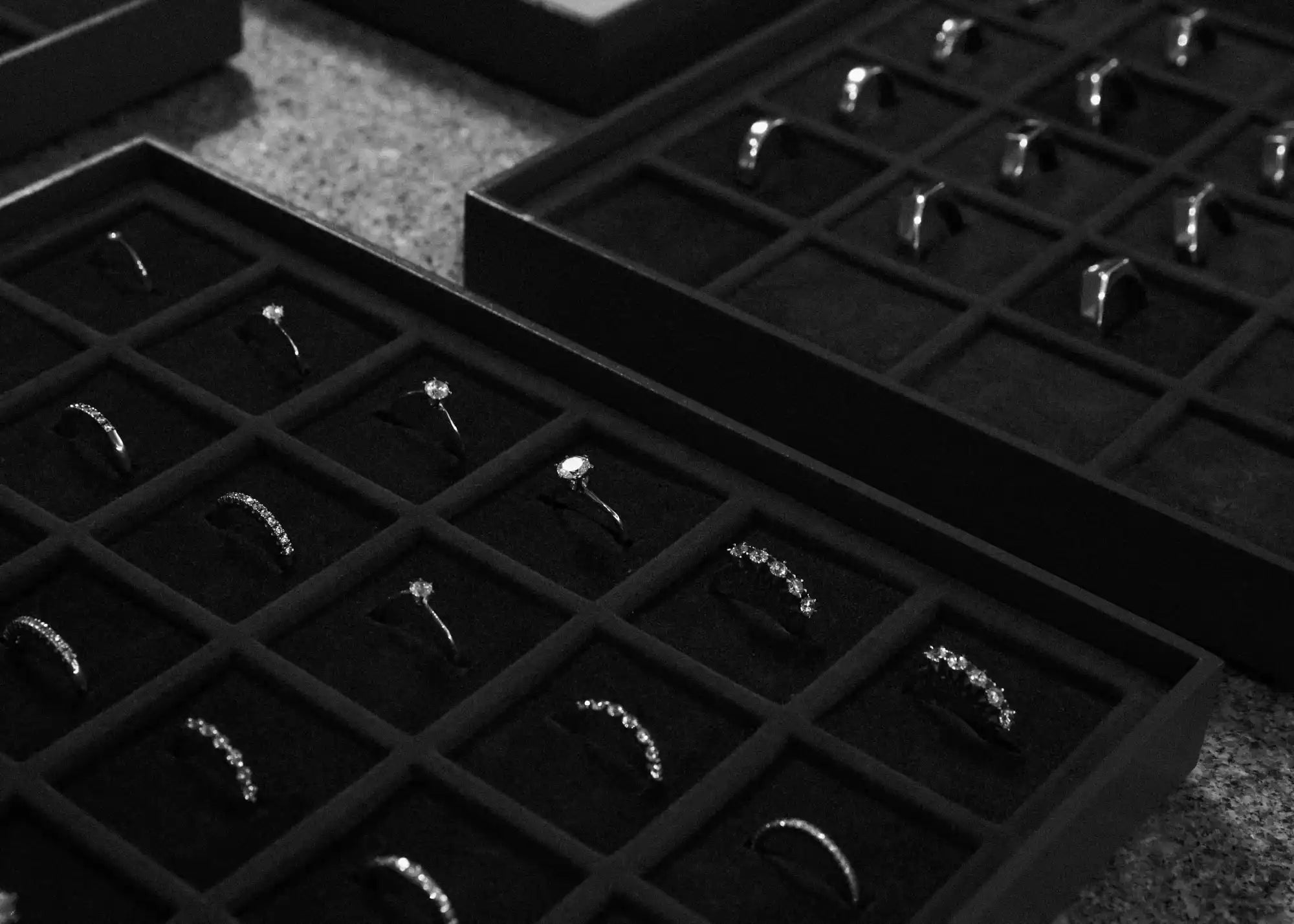 Rings displayed in jewelry trays.